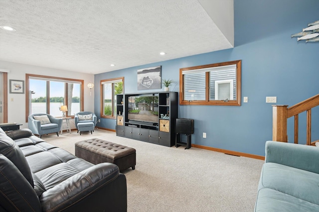 5090 Schrah Dr, Munith, MI 49259 - carpeted living area featuring a textured ceiling, recessed lighting, and stairs