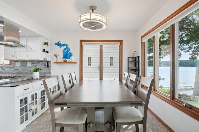 5090 Schrah Dr, Munith, MI 49259 - dining room with light carpet and a water view