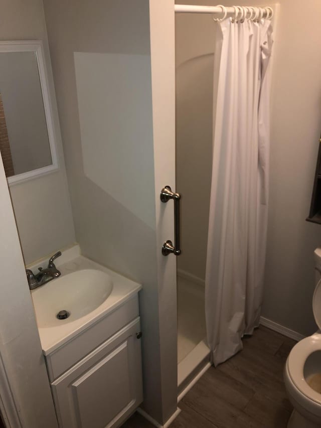 1483 Rose Ave, Benton Harbor, MI 49022 - bathroom featuring wood finished floors, a shower stall, and vanity