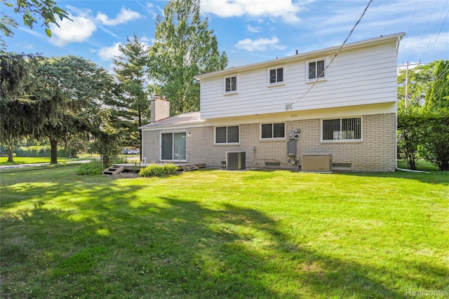 36393 Dardanella St, Livonia, MI 48152 - rear view of property featuring brick siding, a lawn, and a chimney