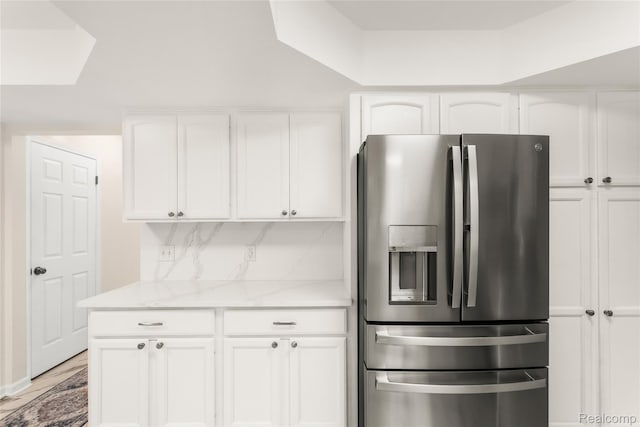 36393 Dardanella St, Livonia, MI 48152 - kitchen featuring stainless steel refrigerator with ice dispenser, white cabinets, light stone countertops, and tasteful backsplash