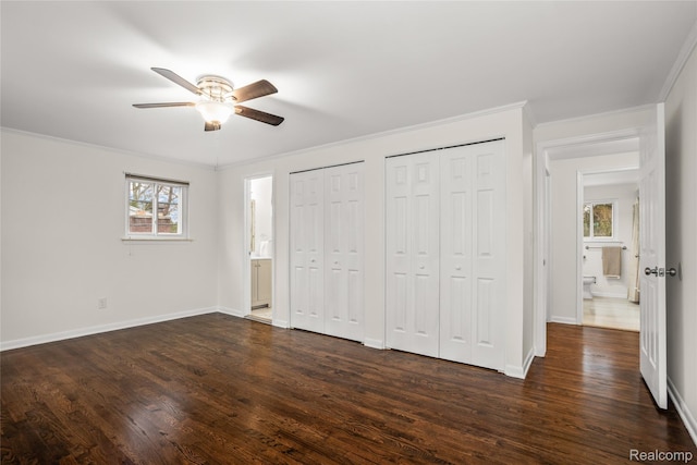 36393 Dardanella St, Livonia, MI 48152 - unfurnished bedroom featuring multiple closets, dark wood-type flooring, ornamental molding, ensuite bathroom, and ceiling fan
