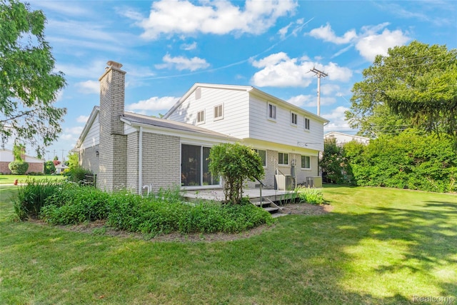 36393 Dardanella St, Livonia, MI 48152 - back of house with a chimney, brick siding, a lawn, and a wooden deck