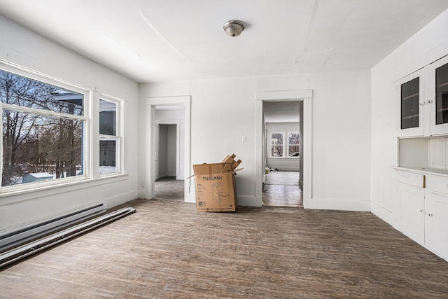 174 Cherry St, Battle Creek, MI 49017 - empty room featuring wood finished floors and a baseboard heating unit