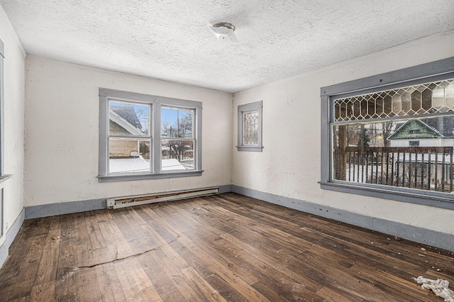 174 Cherry St, Battle Creek, MI 49017 - spare room with baseboard heating, hardwood / wood-style flooring, and a textured ceiling