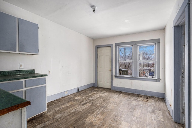 174 Cherry St, Battle Creek, MI 49017 - unfurnished dining area with hardwood / wood-style flooring and baseboards