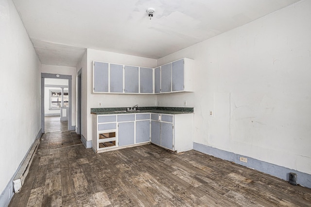 174 Cherry St, Battle Creek, MI 49017 - kitchen featuring dark wood-type flooring and dark countertops