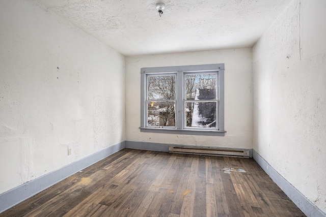 174 Cherry St, Battle Creek, MI 49017 - unfurnished room featuring baseboard heating, hardwood / wood-style flooring, a textured ceiling, and a textured wall