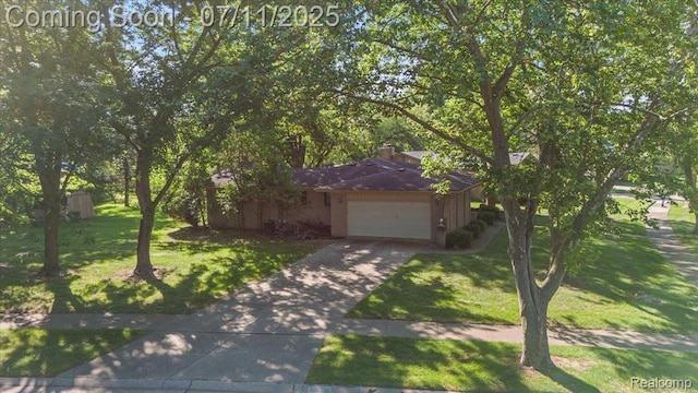4674 Chapel Dr, Troy, MI 48085 - obstructed view of property featuring driveway, a front yard, and a garage