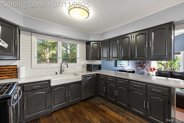 4674 Chapel Dr, Troy, MI 48085 - kitchen featuring stainless steel appliances, dark wood finished floors, light countertops, backsplash, and a peninsula