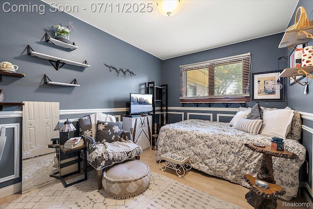 4674 Chapel Dr, Troy, MI 48085 - bedroom with wood finished floors, vaulted ceiling, and wainscoting