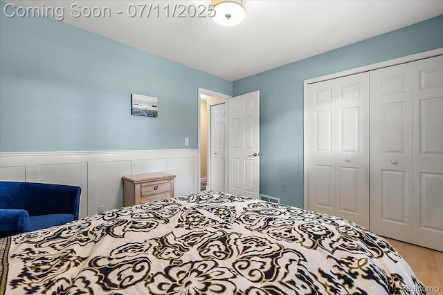 4674 Chapel Dr, Troy, MI 48085 - bedroom featuring a closet, wood finished floors, and wainscoting
