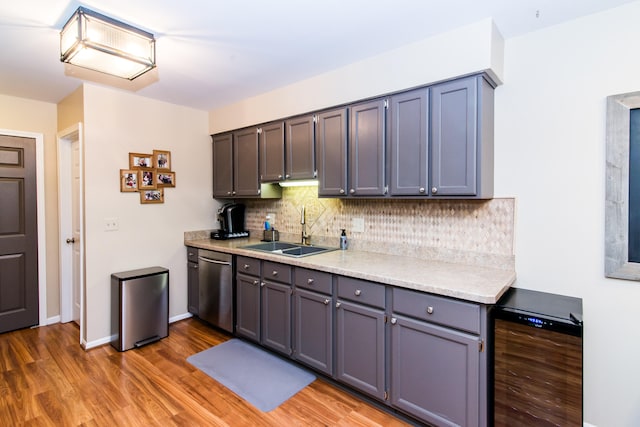 37516 N Laurel Park Dr, Livonia, MI 48152 - kitchen with stainless steel appliances, wine cooler, light countertops, light wood-style flooring, and tasteful backsplash