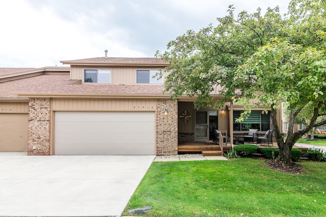 37516 N Laurel Park Dr, Livonia, MI 48152 - view of property with brick siding, a front yard, concrete driveway, roof with shingles, and an attached garage