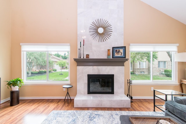 37516 N Laurel Park Dr, Livonia, MI 48152 - living area with wood finished floors, a tiled fireplace, and high vaulted ceiling