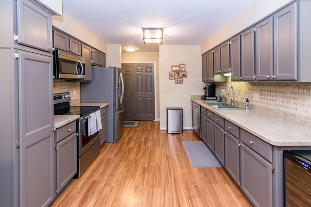 37516 N Laurel Park Dr, Livonia, MI 48152 - kitchen featuring stainless steel appliances, light countertops, tasteful backsplash, and light wood-style floors