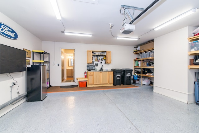 37516 N Laurel Park Dr, Livonia, MI 48152 - garage featuring a garage door opener and freestanding refrigerator