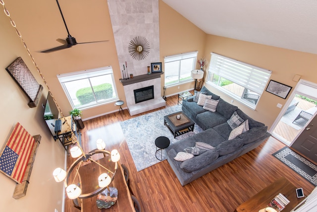 37516 N Laurel Park Dr, Livonia, MI 48152 - living area featuring high vaulted ceiling, wood finished floors, ceiling fan, and a fireplace
