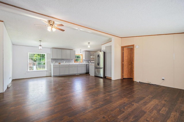 36466 M 40, Paw Paw, MI 49079 - unfurnished living room featuring dark wood finished floors, ceiling fan, a textured ceiling, vaulted ceiling, and crown molding