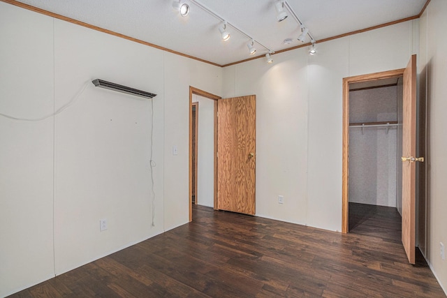 36466 M 40, Paw Paw, MI 49079 - unfurnished bedroom featuring wood finished floors, crown molding, a spacious closet, a closet, and track lighting