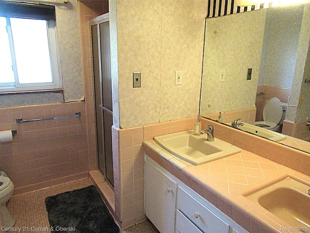 34005 Alta Loma Dr, Farmington, MI 48335 - full bath featuring tile walls, double vanity, a stall shower, a wainscoted wall, and tile patterned flooring
