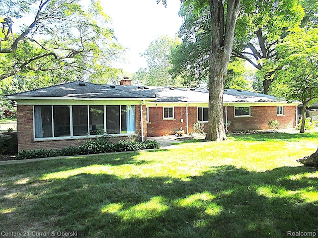 34005 Alta Loma Dr, Farmington, MI 48335 - back of property featuring a yard, brick siding, and a chimney