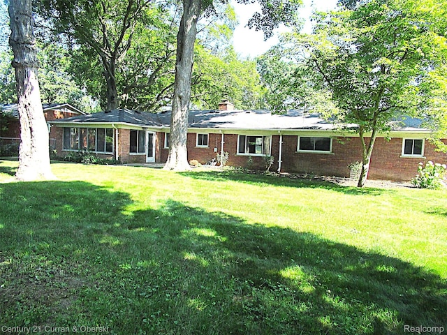 34005 Alta Loma Dr, Farmington, MI 48335 - ranch-style house with a front lawn, brick siding, and a chimney