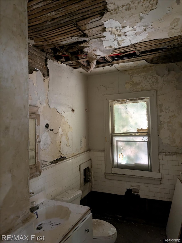 4342 Tyler St, Detroit, MI 48238 - half bathroom with vanity, tile walls, and a wainscoted wall