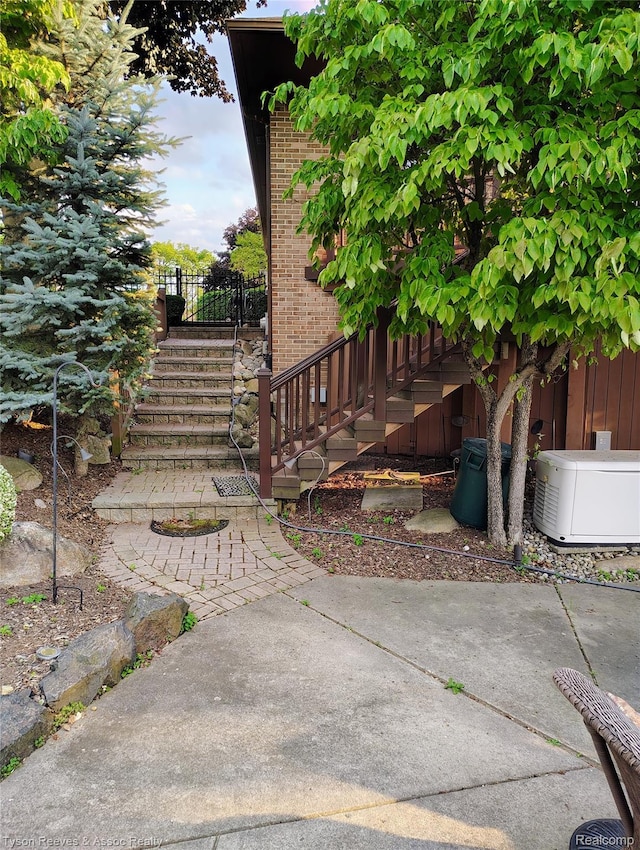 22770 Shadowglen Dr, Farmington Hills, MI 48335 - view of property exterior featuring brick siding and stairs