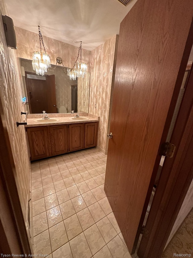 22770 Shadowglen Dr, Farmington Hills, MI 48335 - bathroom featuring a chandelier, double vanity, and tile patterned floors