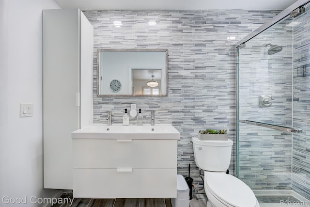 29755 Rosemond Dr, Southfield, MI 48025 - full bathroom with a shower stall, vanity, tile walls, and wood finished floors