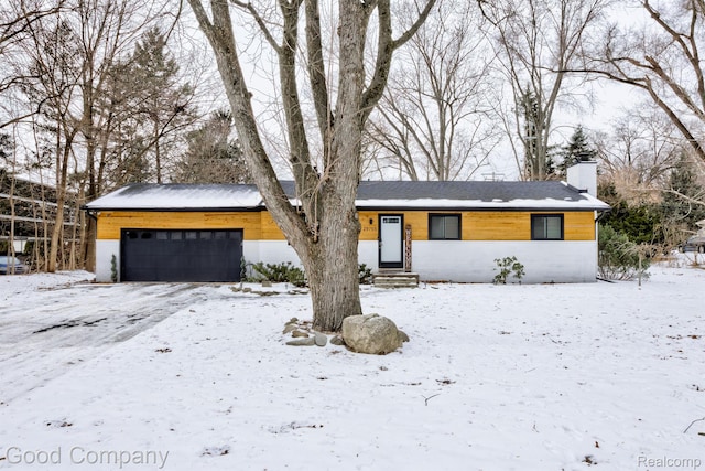 29755 Rosemond Dr, Southfield, MI 48025 - mid-century home with a chimney, a garage, and entry steps