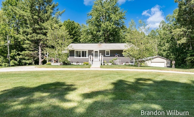2289 S Sullivan Rd, Ravenna, MI 49451 - ranch-style home with a front yard and a detached garage