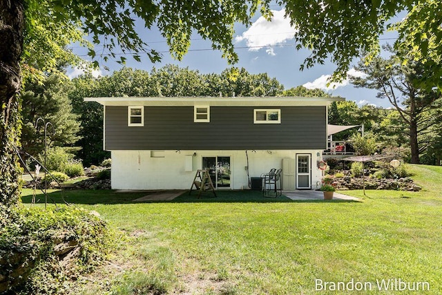 2289 S Sullivan Rd, Ravenna, MI 49451 - rear view of property featuring a lawn and a patio area