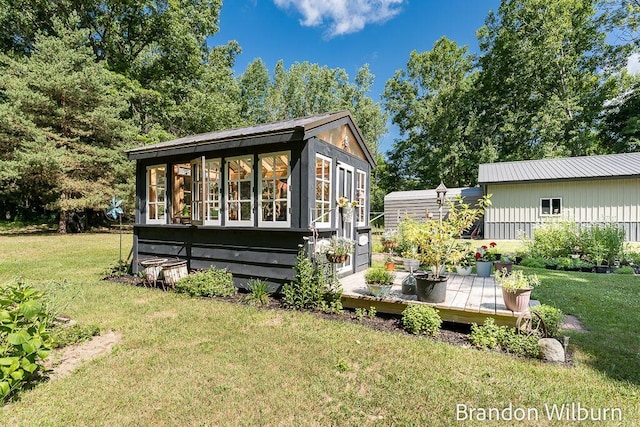 2289 S Sullivan Rd, Ravenna, MI 49451 - back of house with a lawn, an outdoor structure, and a wooden deck