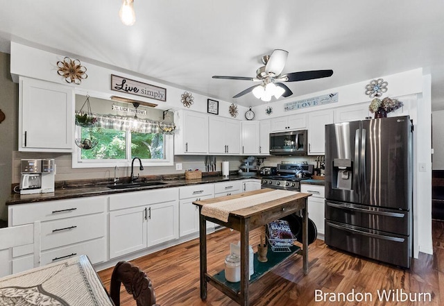 2289 S Sullivan Rd, Ravenna, MI 49451 - kitchen with appliances with stainless steel finishes, dark countertops, white cabinets, and ceiling fan