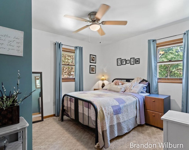 2289 S Sullivan Rd, Ravenna, MI 49451 - bedroom featuring multiple windows, light carpet, and a ceiling fan