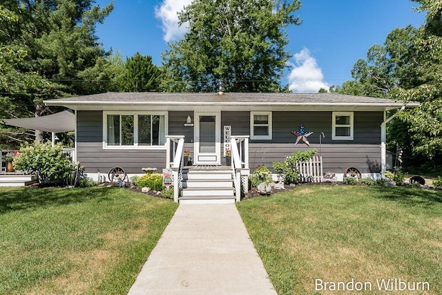 2289 S Sullivan Rd, Ravenna, MI 49451 - bungalow-style house with covered porch and a front lawn