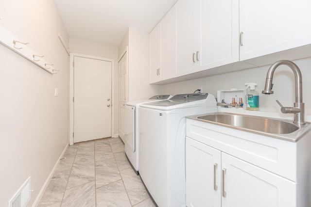 2728 Kimberley Rd, Ann Arbor, MI 48104 - laundry area with light marble finish floors, cabinet space, and washing machine and dryer