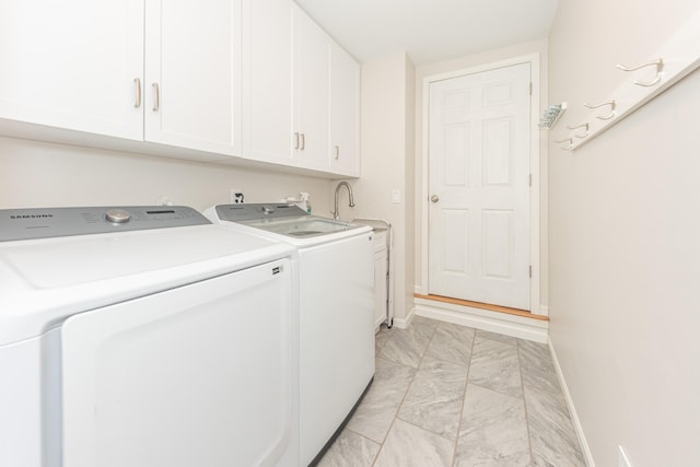 2728 Kimberley Rd, Ann Arbor, MI 48104 - washroom with separate washer and dryer, cabinet space, and light marble finish flooring