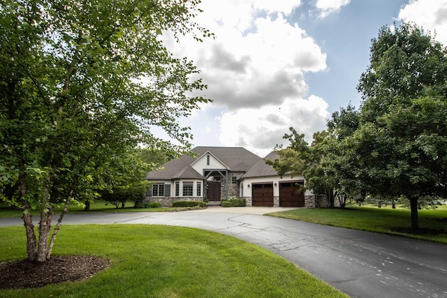 7380 Vassar Rd, Grand Blanc, MI 48439 - view of front facade with stone siding, an attached garage, curved driveway, and a front yard