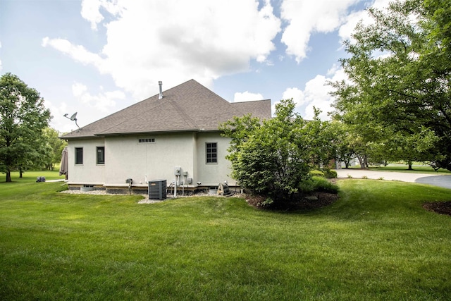7380 Vassar Rd, Grand Blanc, MI 48439 - back of house with stucco siding, a yard, and roof with shingles