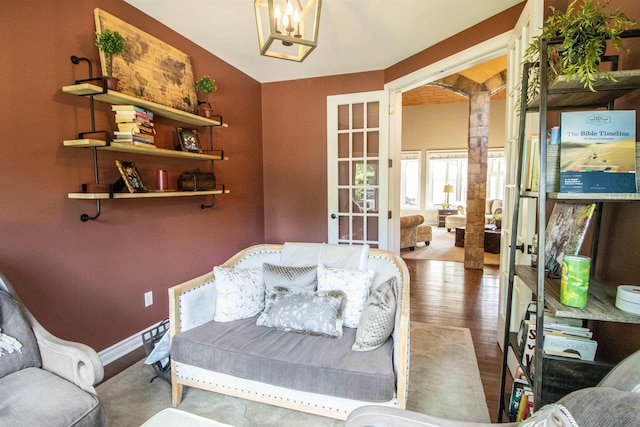 7380 Vassar Rd, Grand Blanc, MI 48439 - living area featuring french doors, wood finished floors, and a chandelier