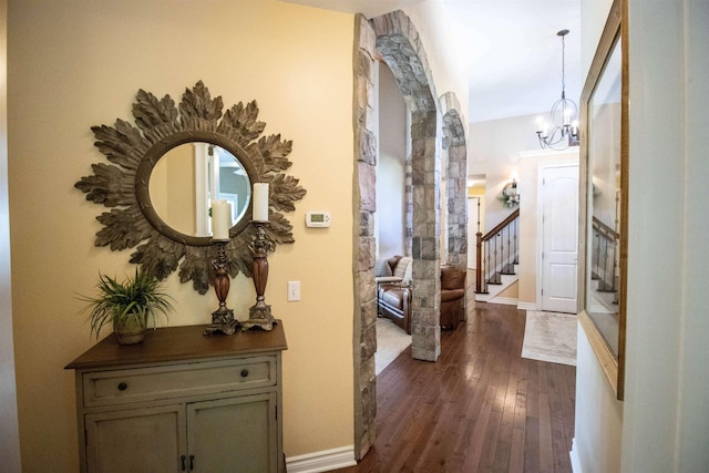 7380 Vassar Rd, Grand Blanc, MI 48439 - hall with dark wood-type flooring, stairway, and a chandelier