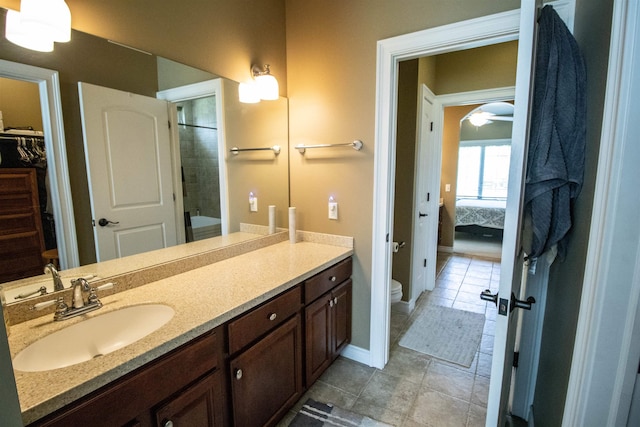 7380 Vassar Rd, Grand Blanc, MI 48439 - bathroom featuring ensuite bath, vanity, a spacious closet, and a ceiling fan