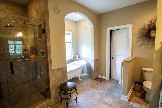 7380 Vassar Rd, Grand Blanc, MI 48439 - bathroom with a stall shower, a freestanding bath, and tile patterned floors