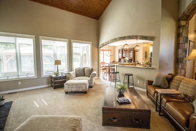 7380 Vassar Rd, Grand Blanc, MI 48439 - living area featuring carpet, high vaulted ceiling, arched walkways, and wood ceiling