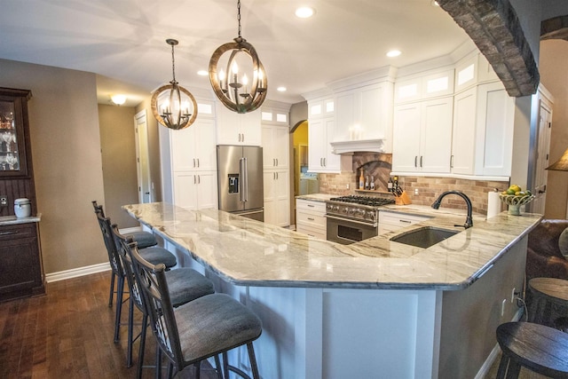 7380 Vassar Rd, Grand Blanc, MI 48439 - kitchen with premium appliances, recessed lighting, light stone counters, tasteful backsplash, and dark wood-style floors