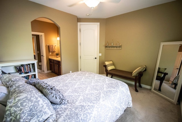 7380 Vassar Rd, Grand Blanc, MI 48439 - bedroom with arched walkways, ceiling fan, ensuite bathroom, and light colored carpet