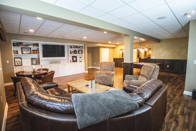 7380 Vassar Rd, Grand Blanc, MI 48439 - living area with wood finished floors, built in shelves, a wainscoted wall, bar, and recessed lighting